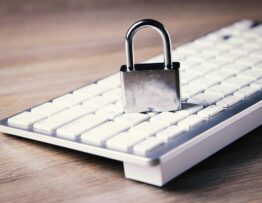 a computer keyboard with a padlock on top of it