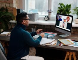 teacher-video-calling-with-his-students-using-a-computer